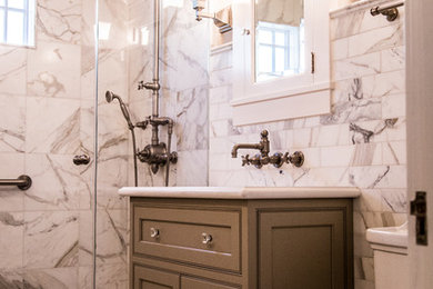 Small transitional 3/4 white tile and marble tile mosaic tile floor and white floor alcove shower photo in San Francisco with shaker cabinets, gray cabinets, white walls, an undermount sink, solid surface countertops and a hinged shower door