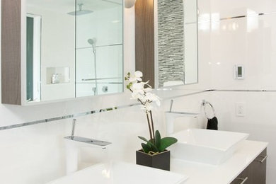 Mid-sized trendy master white tile and ceramic tile ceramic tile and gray floor bathroom photo in Chicago with flat-panel cabinets, black cabinets, white walls, a vessel sink, quartz countertops and white countertops