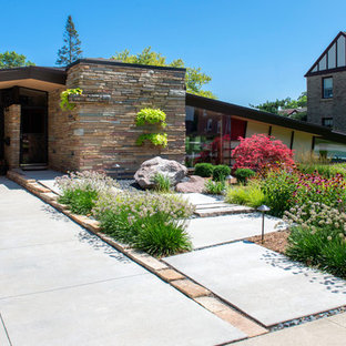 Design ideas for a mid-sized midcentury front yard full sun driveway for summer in Milwaukee with a garden path.