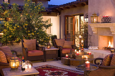 Example of a mid-sized tuscan backyard concrete paver patio design in San Francisco with a fire pit and no cover