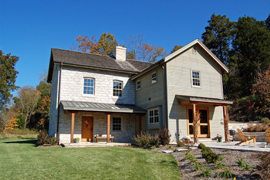 Inspiration for a country two-storey exterior in St Louis with mixed siding.