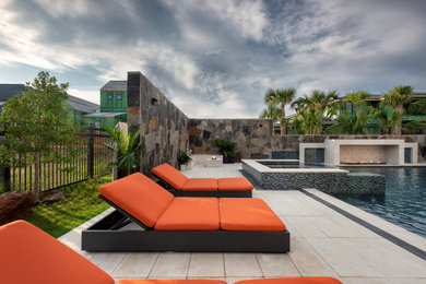Large island style backyard stone and custom-shaped privacy pool photo in Dallas