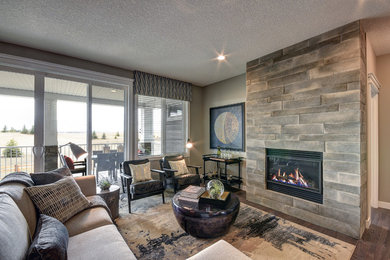 Example of a mid-sized transitional formal and enclosed medium tone wood floor and brown floor living room design in Calgary with beige walls, a standard fireplace, a wood fireplace surround and no tv