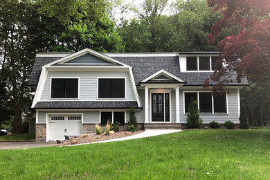 Mid-sized traditional gray two-story vinyl house exterior idea in New York with a gambrel roof and a shingle roof
