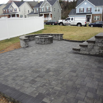 Paver Patio with outdoor fire pit and seating wall along with steps.
