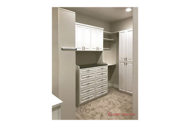 Example of a classic walk-in closet design in Sacramento with white cabinets