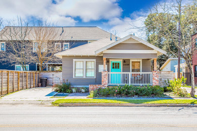 Small transitional beige one-story vinyl gable roof photo in Houston