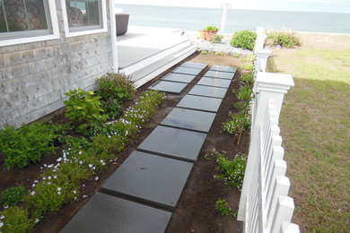 Design ideas for a mid-sized coastal partial sun backyard concrete paver landscaping in Boston.