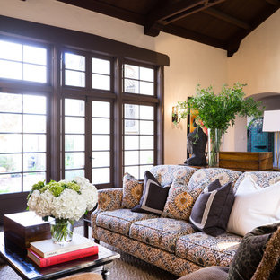 Medium sized mediterranean enclosed living room in San Francisco with white walls, a standard fireplace, a wooden fireplace surround, a wall mounted tv and dark hardwood flooring.