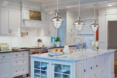 Example of a large transitional single-wall enclosed kitchen design in Toronto with a farmhouse sink, shaker cabinets, white cabinets, marble countertops, white backsplash, subway tile backsplash, stainless steel appliances and an island