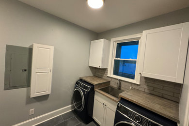 Laundry room - coastal laundry room idea in Other