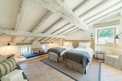 This is an example of a large mediterranean bedroom in Other with white walls and ceramic floors.