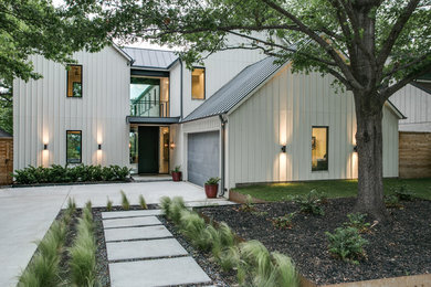 Photo of a large transitional two-storey white exterior in Dallas with wood siding and a gable roof.