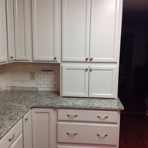 White 2x4 tile backsplash with black line accent