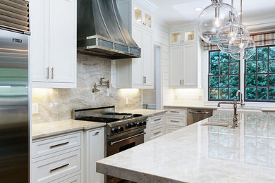 Example of a large transitional u-shaped medium tone wood floor and brown floor eat-in kitchen design in Atlanta with a farmhouse sink, recessed-panel cabinets, gray cabinets, quartzite countertops, beige backsplash, stone slab backsplash, stainless steel appliances, an island and beige countertops