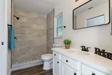 Example of a mid-sized classic 3/4 beige tile pebble tile floor and multicolored floor bathroom design in Tampa with shaker cabinets, white cabinets, white walls, white countertops and a built-in vanity