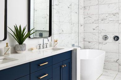 Example of a mid-sized transitional master bathroom design in DC Metro with blue cabinets and white countertops