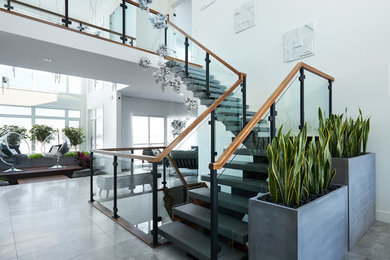 This is an example of a large modern concrete floating staircase in Edmonton with mixed railing.