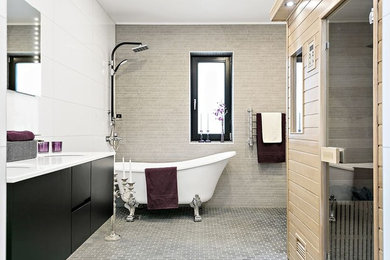 Inspiration for a mid-sized transitional 3/4 bathroom in Stockholm with flat-panel cabinets, black cabinets, a shower/bathtub combo, beige tile, white tile, white walls, grey floor, an open shower and white benchtops.