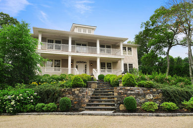 Large arts and crafts beige three-story vinyl exterior home photo in New York
