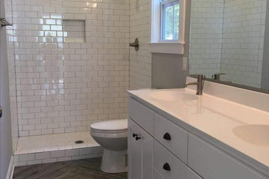 Bathroom - small double-sink bathroom idea in Kansas City with a one-piece toilet and a built-in vanity