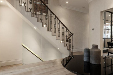 Design ideas for a mid-sized contemporary hallway in London with white walls, light hardwood floors and grey floor.