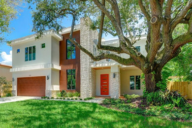 Example of a minimalist white two-story exterior home design in Tampa