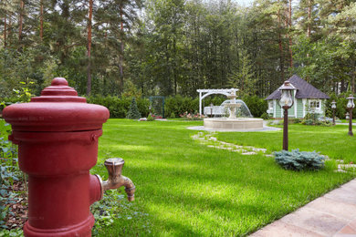 Diseño de patio clásico grande en patio con fuente, adoquines de piedra natural y pérgola