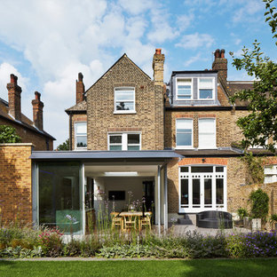 This is an example of a traditional brick exterior in London with three or more floors and a pitched roof.