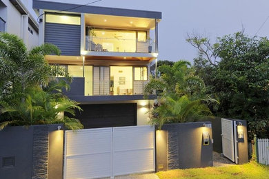 Design ideas for a large contemporary two-storey white exterior in Brisbane with mixed siding and a flat roof.