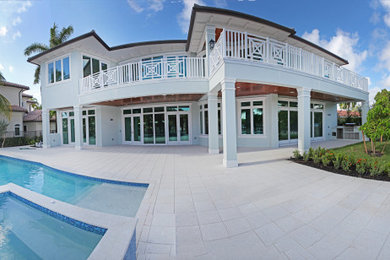 Large contemporary white two-story house exterior idea in Miami