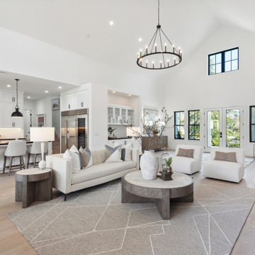 Open floor plan with 24 ft vaulted ceilings and light-toned wood flooring