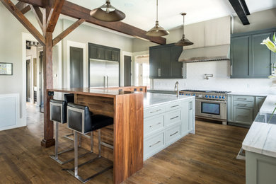 Inspiration for a large country l-shaped medium tone wood floor, brown floor and exposed beam open concept kitchen remodel in Richmond with a farmhouse sink, shaker cabinets, gray cabinets, quartzite countertops, white backsplash, subway tile backsplash, stainless steel appliances and an island