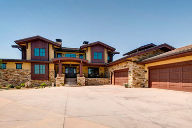 Large craftsman multicolored two-story mixed siding exterior home idea in Denver with a shingle roof