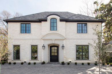 Transitional white two-story stone house exterior idea in Dallas with a hip roof and a shingle roof