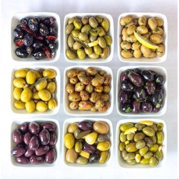 Varieties of Olives in bowls on white background Print