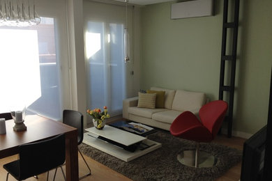 Example of a small trendy formal and loft-style medium tone wood floor living room design in Madrid with a tv stand