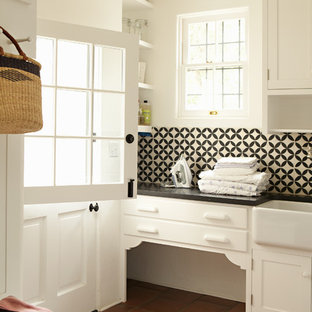 Photo of a classic utility room in Los Angeles with a belfast sink, terracotta flooring and red floors.