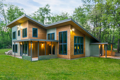 Large contemporary multicolored two-story mixed siding house exterior idea in Detroit with a shed roof