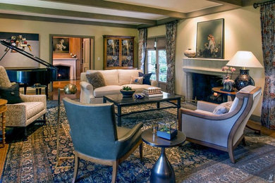 Inspiration for a large timeless enclosed medium tone wood floor and brown floor living room remodel in Denver with beige walls, a standard fireplace, a stone fireplace and no tv