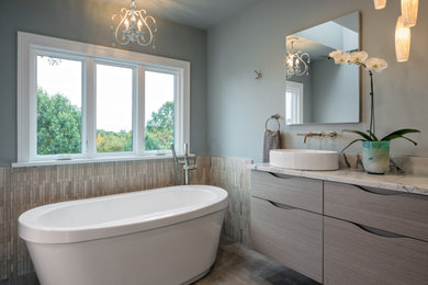 Inspiration for a mid-sized contemporary marble tile ceramic tile and double-sink freestanding bathtub remodel in Other with flat-panel cabinets, a vessel sink, quartzite countertops and a floating vanity