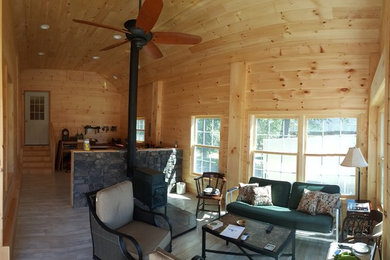 Sunroom - large farmhouse light wood floor sunroom idea in Boston with a wood stove, a stone fireplace and a standard ceiling