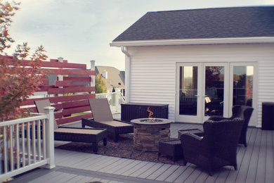 Example of a mid-sized minimalist backyard deck design in Boise with no cover