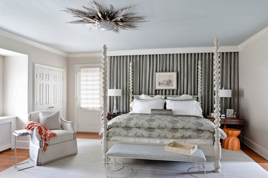 Example of a mid-sized transitional master medium tone wood floor and brown floor bedroom design in DC Metro with white walls and no fireplace
