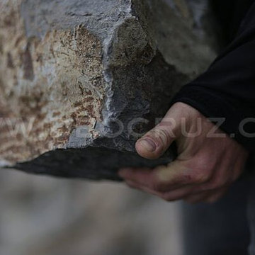 Basalt Boulder Wall. Hand picking and chiseling