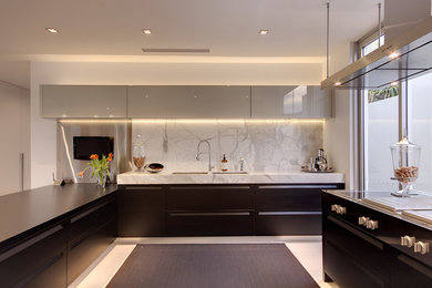 This is an example of a large modern u-shaped eat-in kitchen in Brisbane with travertine floors, an undermount sink, recessed-panel cabinets, marble benchtops, stone slab splashback, panelled appliances and with island.