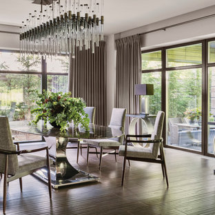 Medium sized modern dining room in London with white walls, dark hardwood flooring and brown floors.
