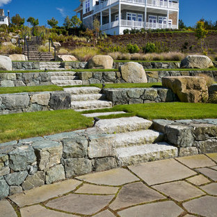 Inspiration for a beach style full sun garden in Providence with natural stone pavers and with rock feature.