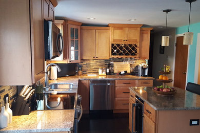 Example of a mid-sized classic l-shaped dark wood floor eat-in kitchen design in Miami with a double-bowl sink, recessed-panel cabinets, light wood cabinets, granite countertops, gray backsplash, matchstick tile backsplash, stainless steel appliances and an island