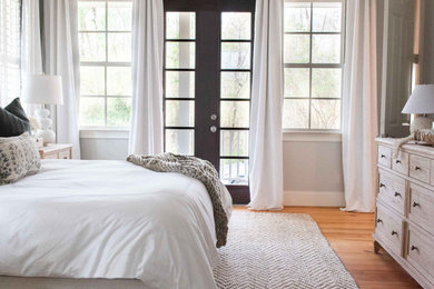 Mid-sized beach style master medium tone wood floor and brown floor bedroom photo in Charleston with blue walls and no fireplace